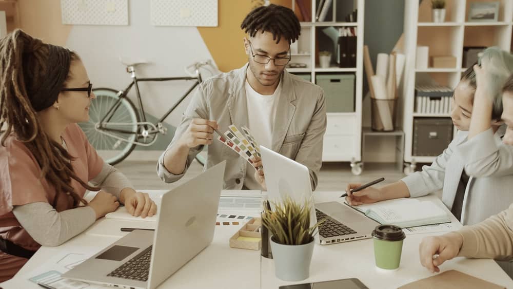 Diverse creative team discussing colour samples in a modern office