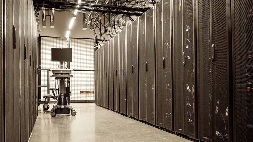 Aisle of server racks inside a data centre