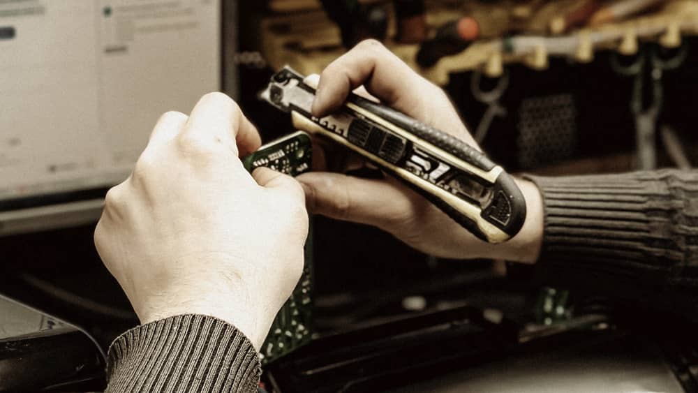Technician working on detailed electronic components
