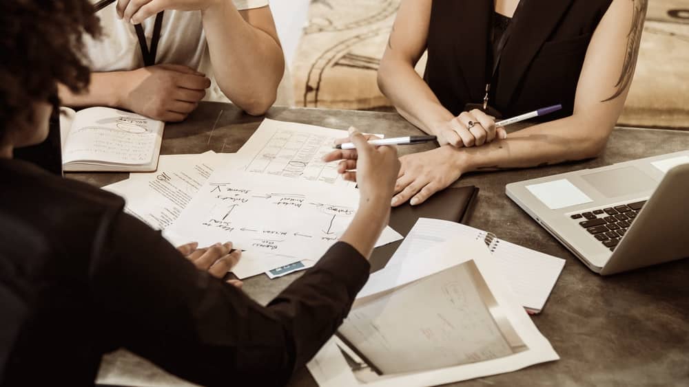 Professionals planning strategies around a meeting table