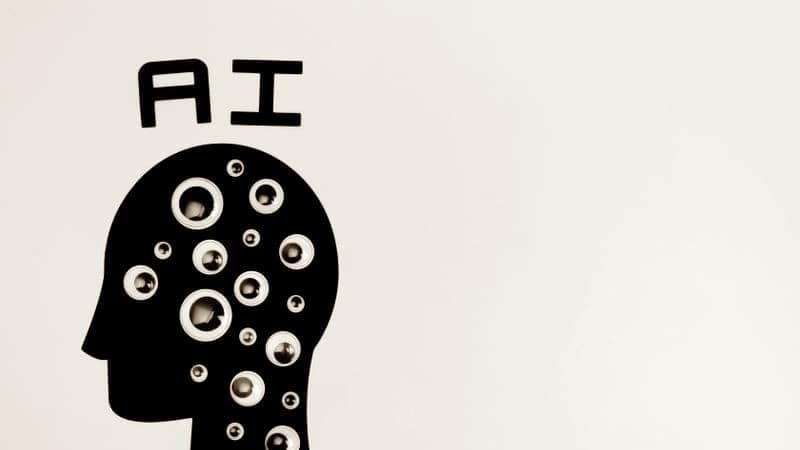 Graphic of a head labelled AI filled with watching eyes