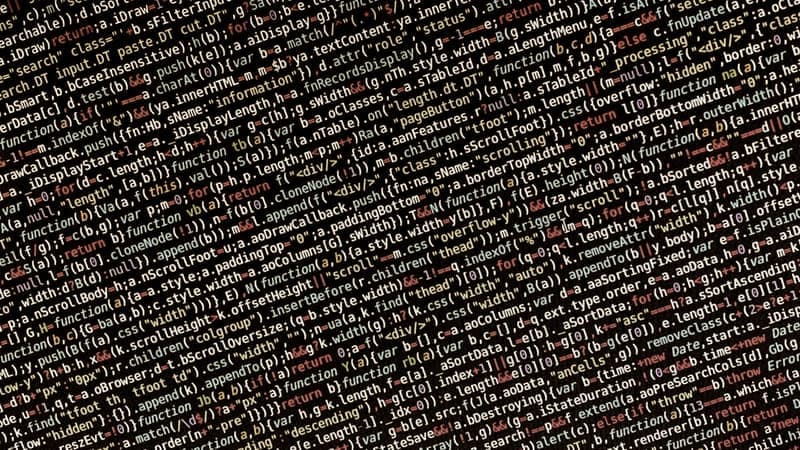Dense lines of programming code on a dark screen