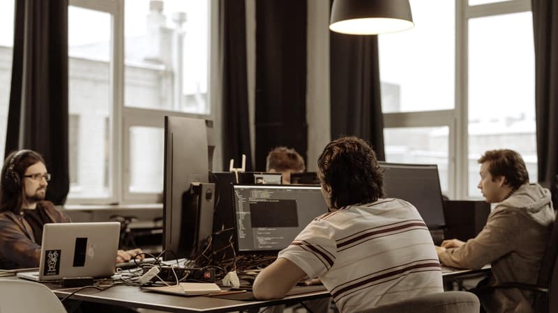 Software team working at desks in an open-plan office