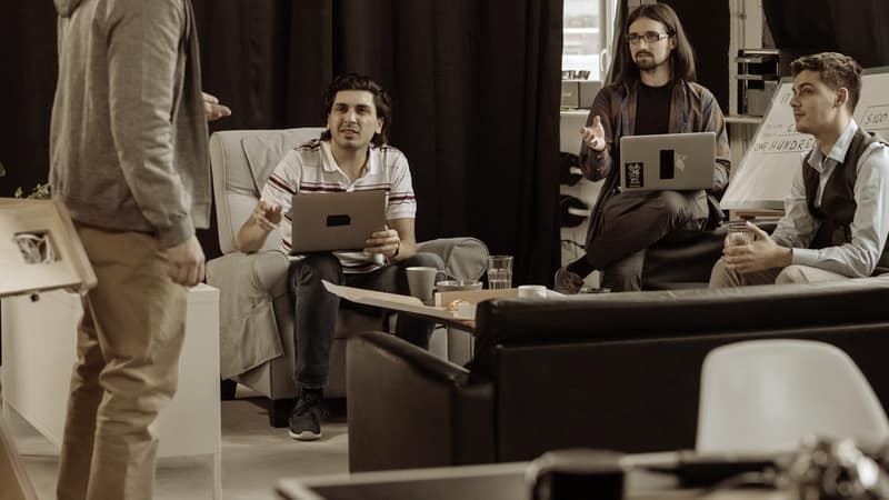 Colleagues meeting with laptops in a modern office