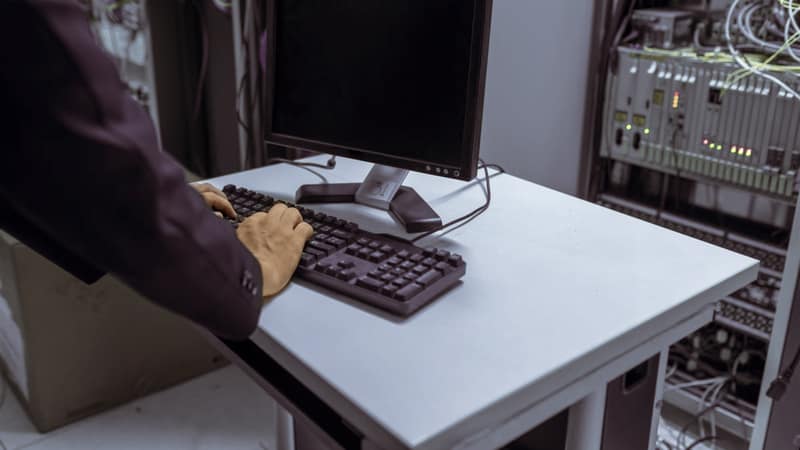 Technician working at a console in a data centre