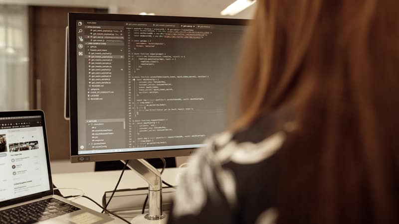 Developer reviewing code on a large monitor